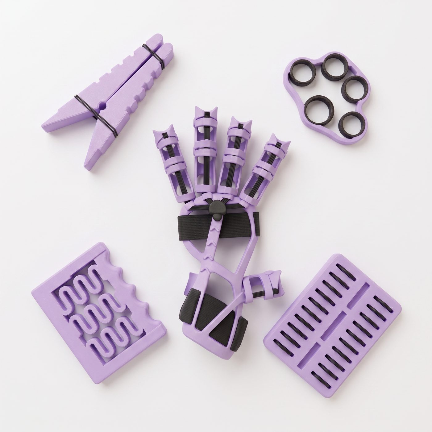 Las cinco piezas del kit Rehab-X sobre fondo claro: pinza instrumentada, anillos de prensión, exoesqueleto Motus-R, track de coordinación y tablero de destreza